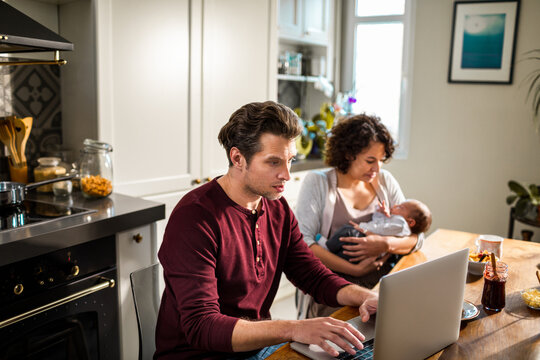 New parents with their baby at the dining table
