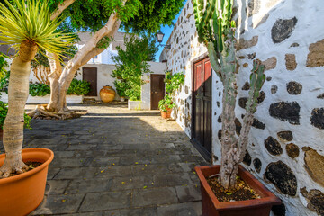A picturesque neighborhood of whitewashed homes with stone accents, wooden doors and plants in the old town center of Arrecife, Spain, on the Canary island of Lanzarote.