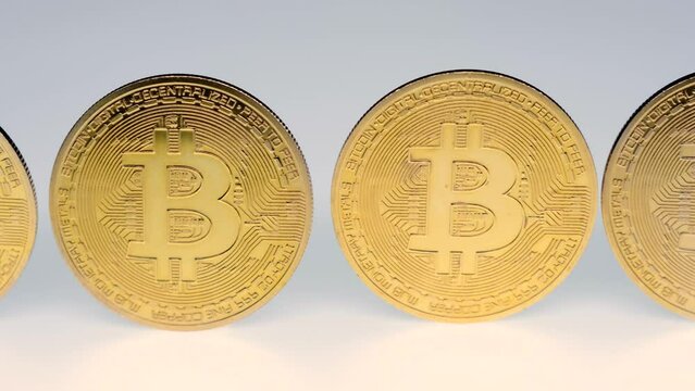 Bitcoin BTC coins close-up on a white background. Digital crypto coin and cryptocurrency. Concept of stock market and online trading.