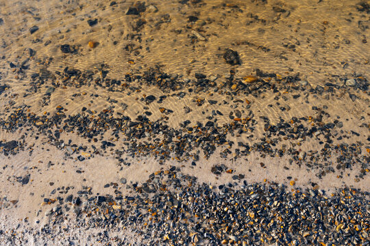 Sea with sandy beach and with pebbles 