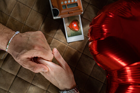 the hands of a couple in love touch each other romantically