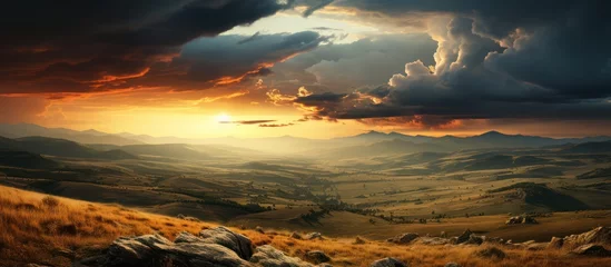 Fotobehang Golden light against moody sky in beautiful rural landscape hills © GoDress
