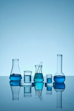 Blue liquid in the transparent test tube and blue background