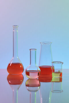 Research lab assorted glassware on color background
