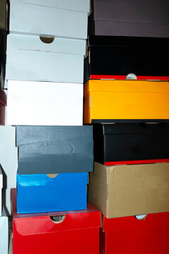Colourful shoe boxes in towers / stacks with hard direct flashlight