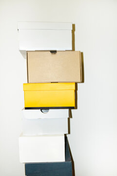 Colourful shoe boxes in towers / stacks with hard direct flashlight