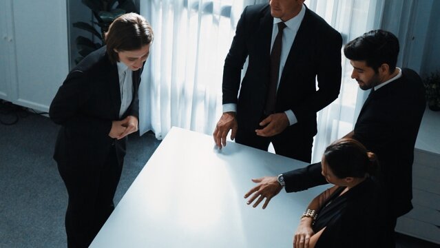 Top view of project manager looking at meeting table surrounded by diverse business people brainstorm and planning strategy. Group of smart people discussing and solve business problems. Directorate.