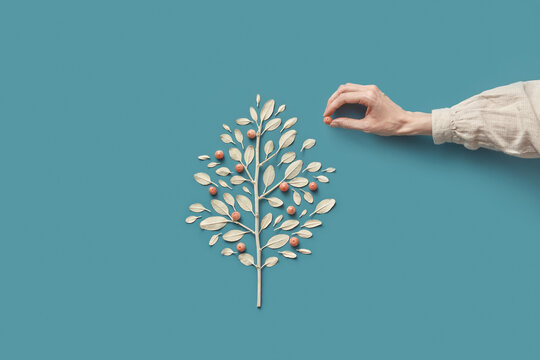 Woman putting paradise apple into creative pattern of leaves