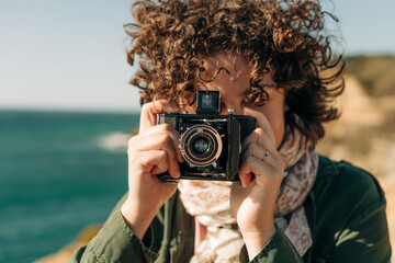 Close up of a woman using vintage camera