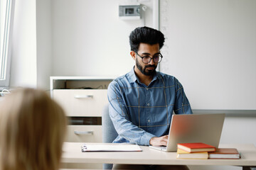 Schoolteacher laptop ponder lesson learning process up-to-date focused