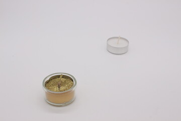 Image of glasses with candles on a light background.