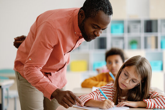Teacher advising pupil during lesson