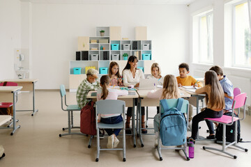 Students study  project with their teacher