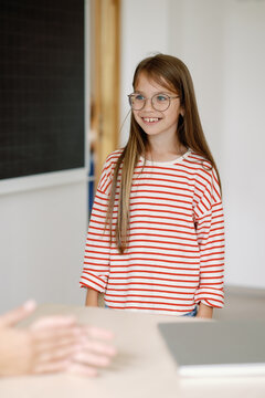 School kid having conversation with teacher 