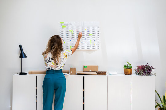  Woman planning weekly schedule at office 
