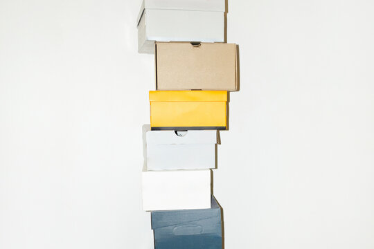 Colourful shoe boxes in towers / stacks with hard direct flashlight