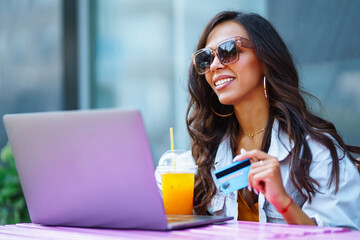 Young woman with laptop in cafe. Freelancer, business, online, education concept. Shopping online