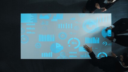 Diverse business people group discussing and brainstorming about marketing strategy with hologram of data analysis statistic or marketing investment graph while sitting at meeting room. Directorate.