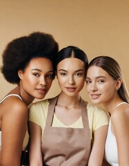 Beauty. Multi Ethnic Group of Womans with diffrent types of skin together against beige background 