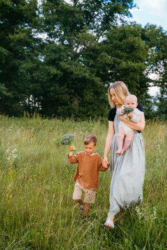 Mom and kids walking in the field