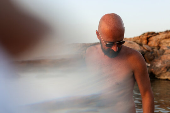 Person At Beach Searching Looking Down For Something On The Ground 