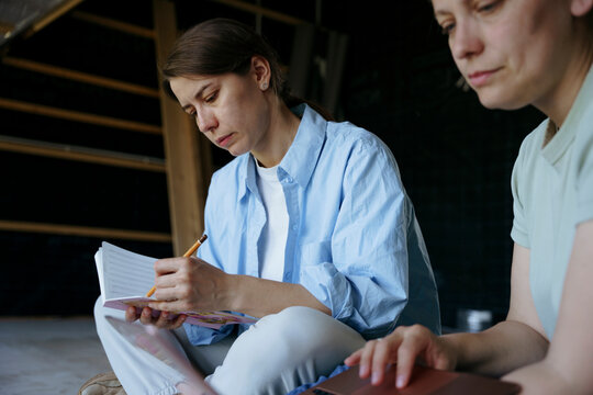 Women talk about the project in an unfinished house