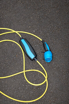 Photo of modern charger / wire of electric car with hard flashlight