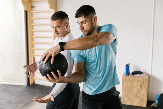 Lifestyle image of two athlete man workout at the gym