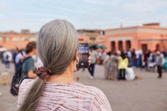 Older woman takes photos with cellphone in Marrakesh 