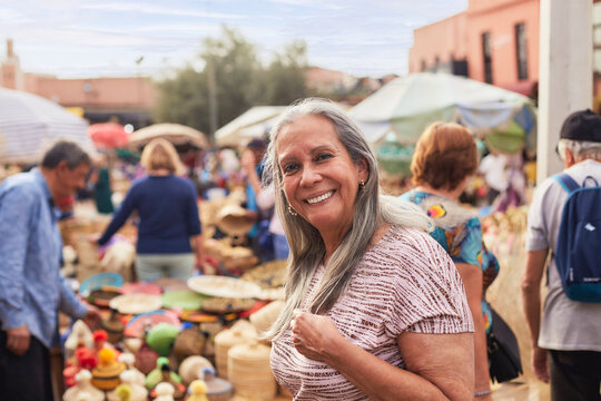 Portrait of an older traveler smiling at the camera in Marrakesh.