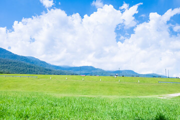 Landscape view of green grass on slope with clouds and blue sky,Beautiful green hills, pastures and...