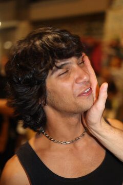 Anonymous man touching his friend's face at underground street party