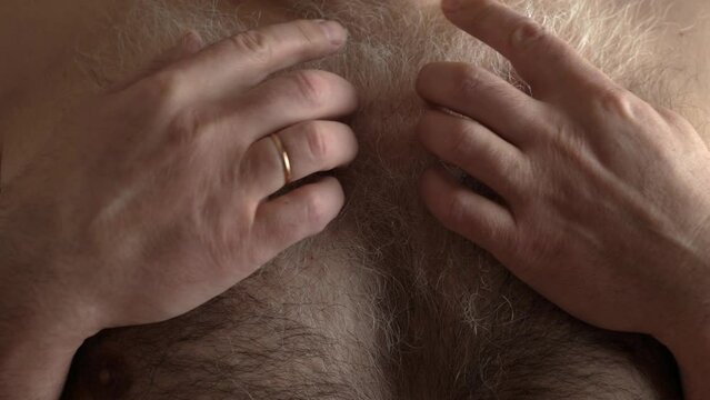 Thick gray hair on the man's chest.