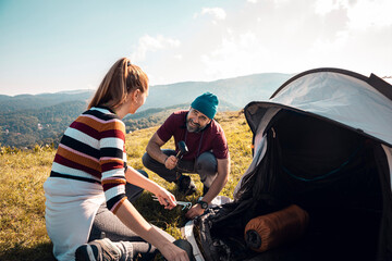 Young couple camping with tent in the mountains