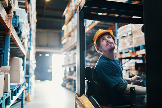 Male forklift operator working in warehouse