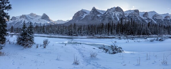 Scenic Frozen Bow River Panoramic Landscape Snow Covered Mountain Peaks Cold Winter Day. Canmore Alberta Canadian Rockies Banff National Park Skyline