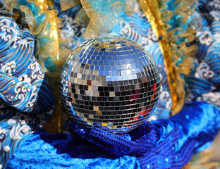 disco ball made of many reflective mirrors held by a dancer