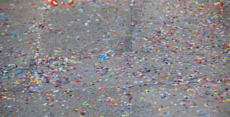 background of many multicolored paper confetti on the floor