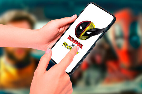 Logo of Deadpool & Wolverine movie on phone screen