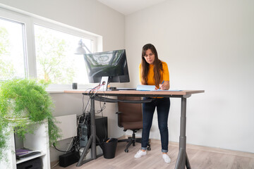Woman Working At Lift Desk In Office