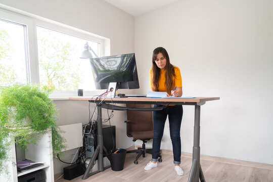 Woman Working At Lift Desk In Office