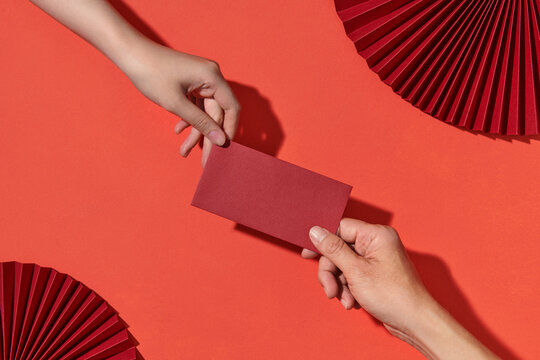 Giving red lucky money envelope to each other