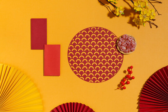 Lunar New Year flat lay with lucky money envelopes and decoration