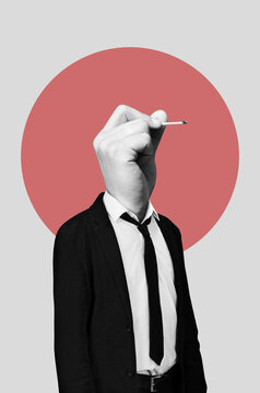 A man with a hand holds a burnt match instead of a head