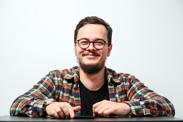 Portrait of young smiling caucasian man on white background. Man wearing eyeglasses, watch and...