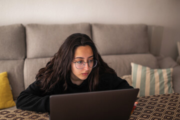 teenager with laptop at home
