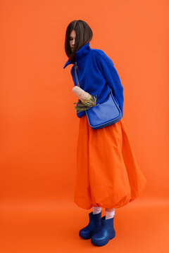 Bashful shy woman in colorful outfit 