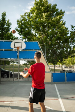 teenage boy playing basketball