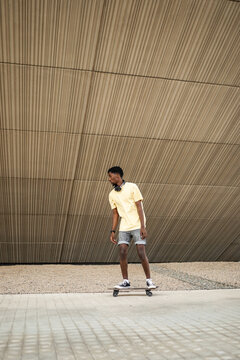 teenage black boy rollerblading around the city