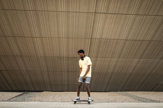 teenage black boy rollerblading around the city
